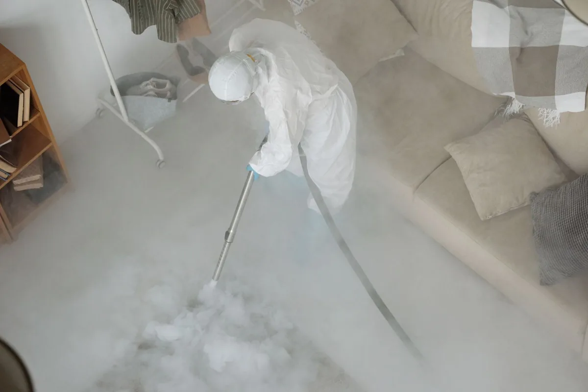 Biohazard cleanup technician in protective equipment, Rand, WV